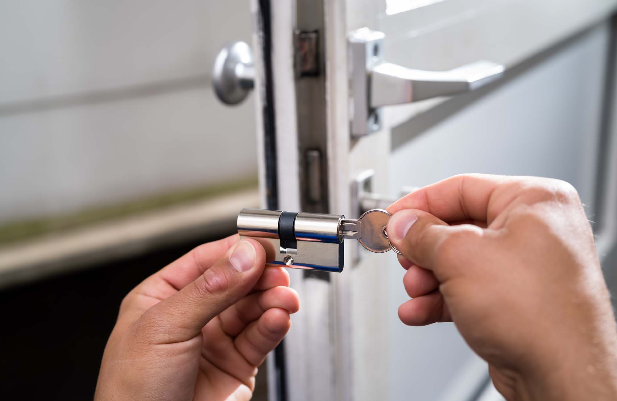 Locksmith Lock Door Repair. Worker Changing And Cylinder in Ashford. Kent