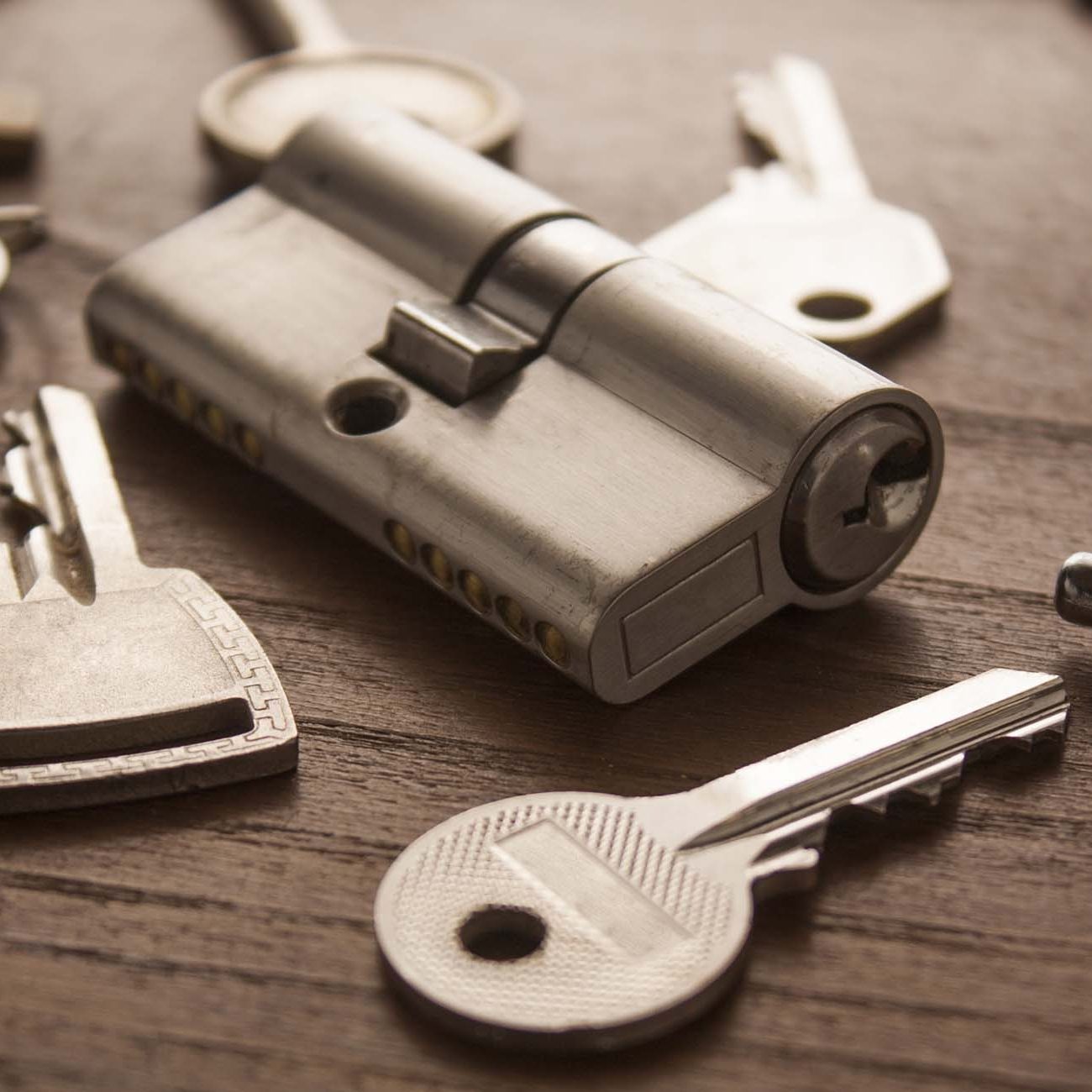 Door lock with keys on wooden surface in Ashford. Kent